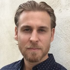 Travis E.